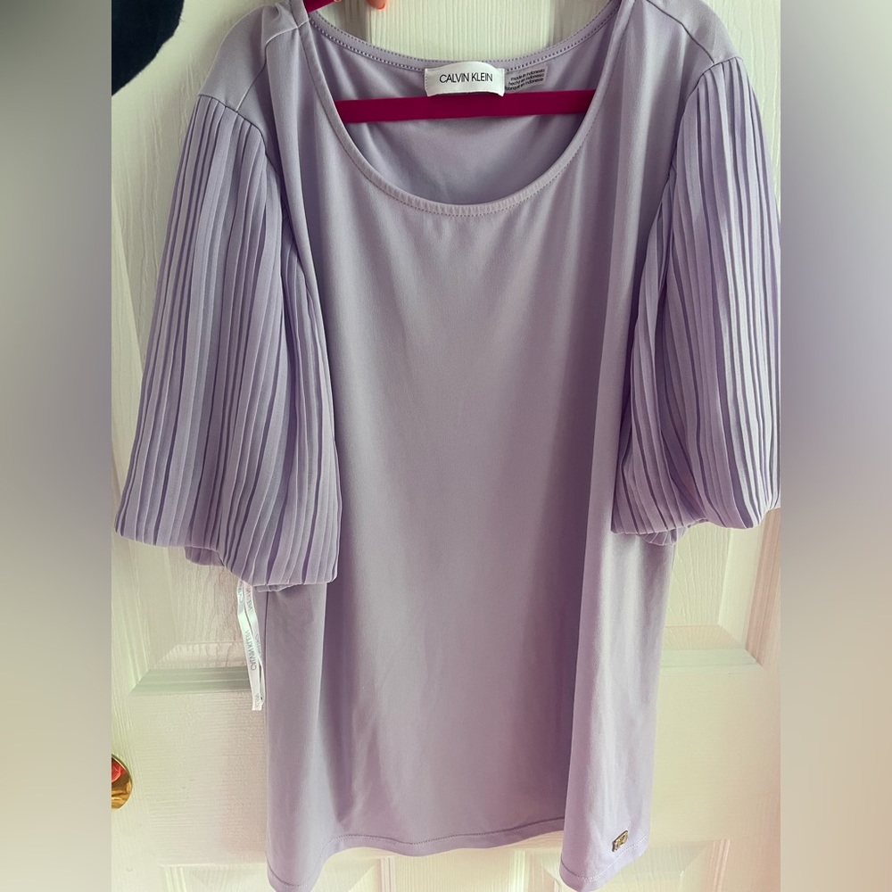 Lilac Clavin Klein short sleeve shirt with puffed sleeve details.